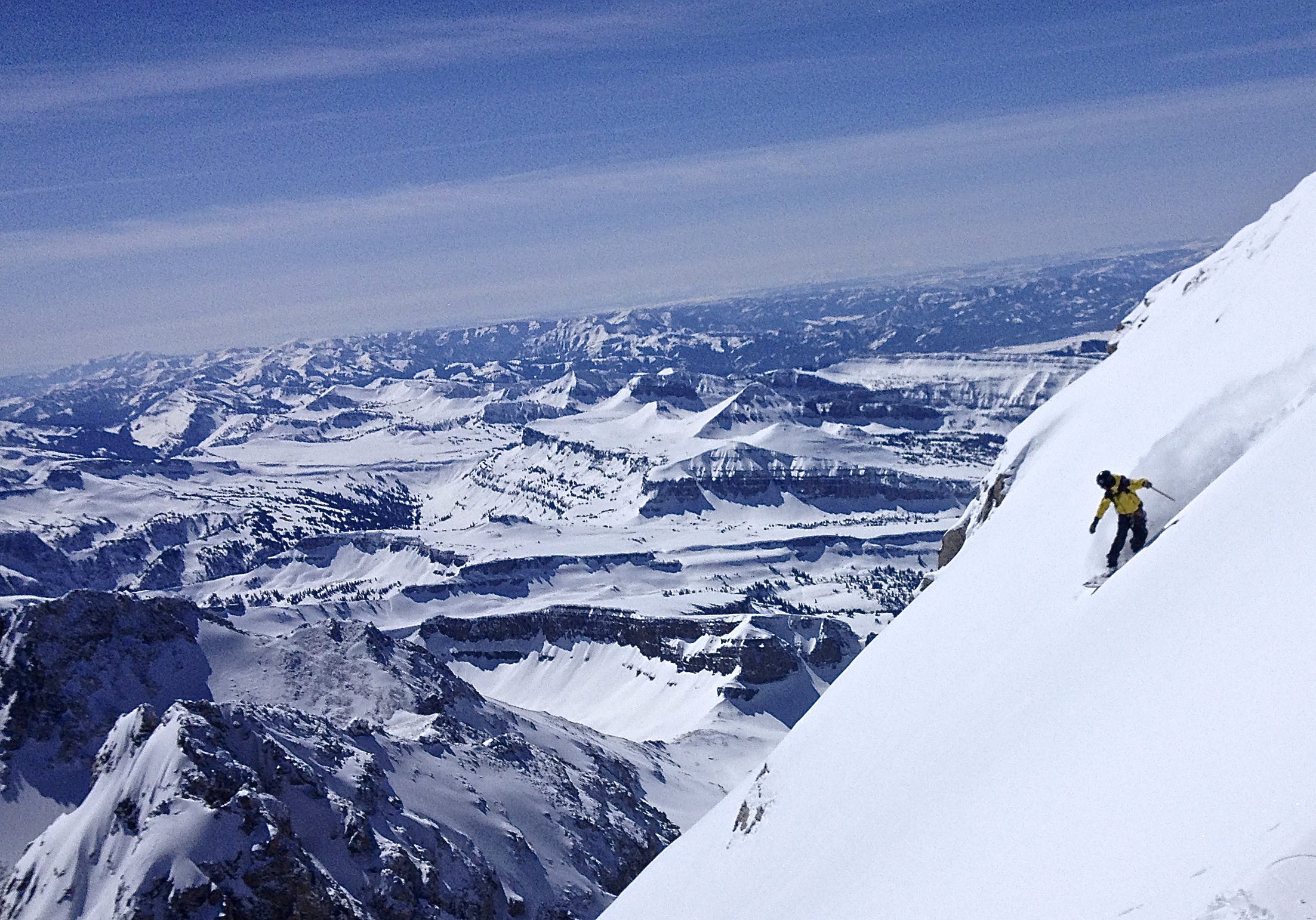 A skier descending a steep snowy mountain demonstrating the five resolutions of the lifelong athlete.